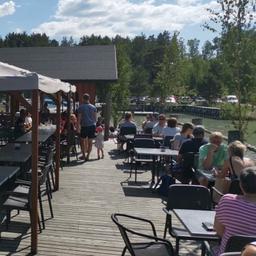 Guests dining on the terrace of Peterzens restaurant on a sunny day.