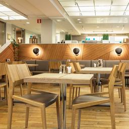 The interior of Bryggman's Restaurant & Deli, featuring modern furniture made from wood.