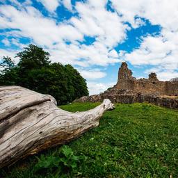 A blue sky dotted with white clouds watches over the Kuusisto Bishop's Castle Ruins, the remains of a once grand building.